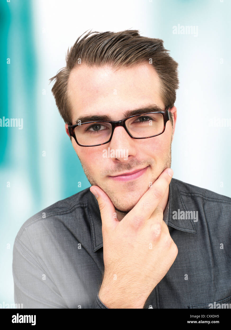 Young businessman wearing glasses, portrait, sly glance Stock Photo - Alamy