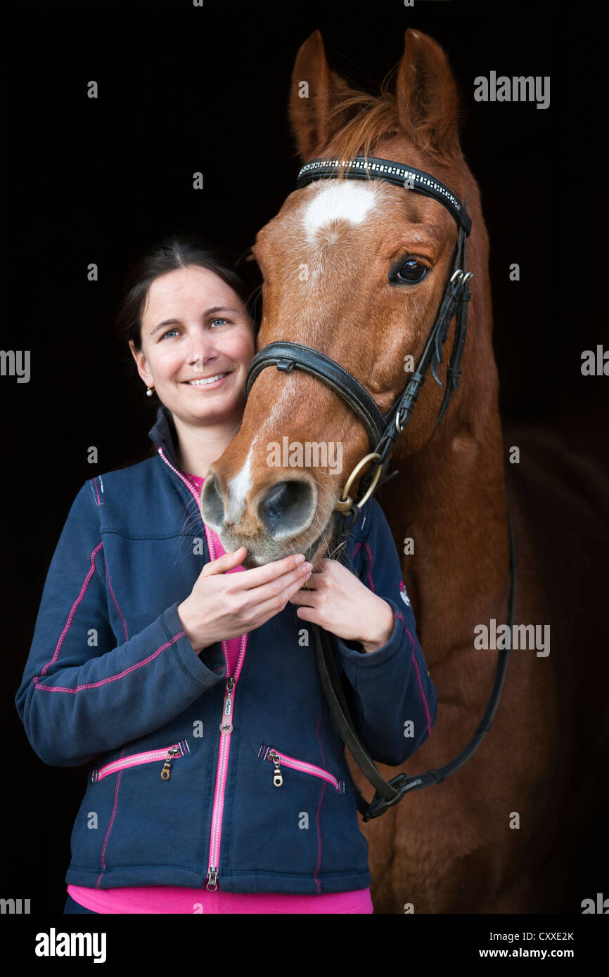 Woman with an Austrian warmblood horse, gelding, chestnut colour, old horse, North Tyrol, Austria, Europe Stock Photo