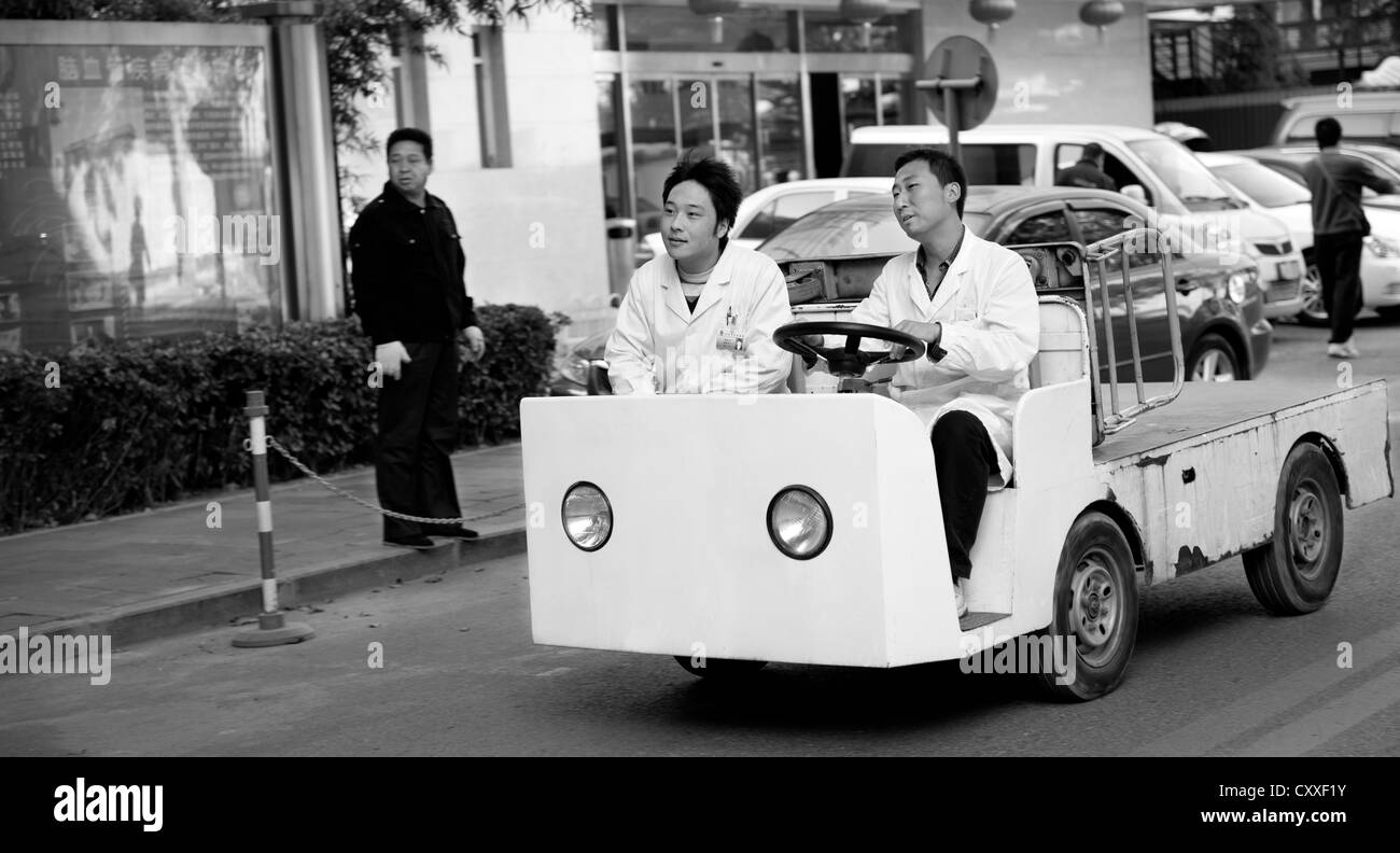 Beijing, China. Staff of the Military General Hospital driving an electric vehicle. Stock Photo