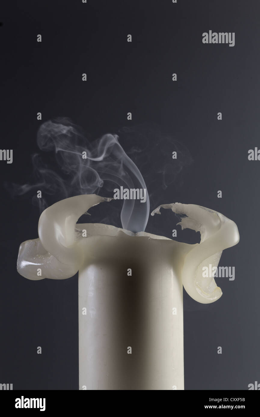 White candle with deformed wax and smoking wick Stock Photo Alamy