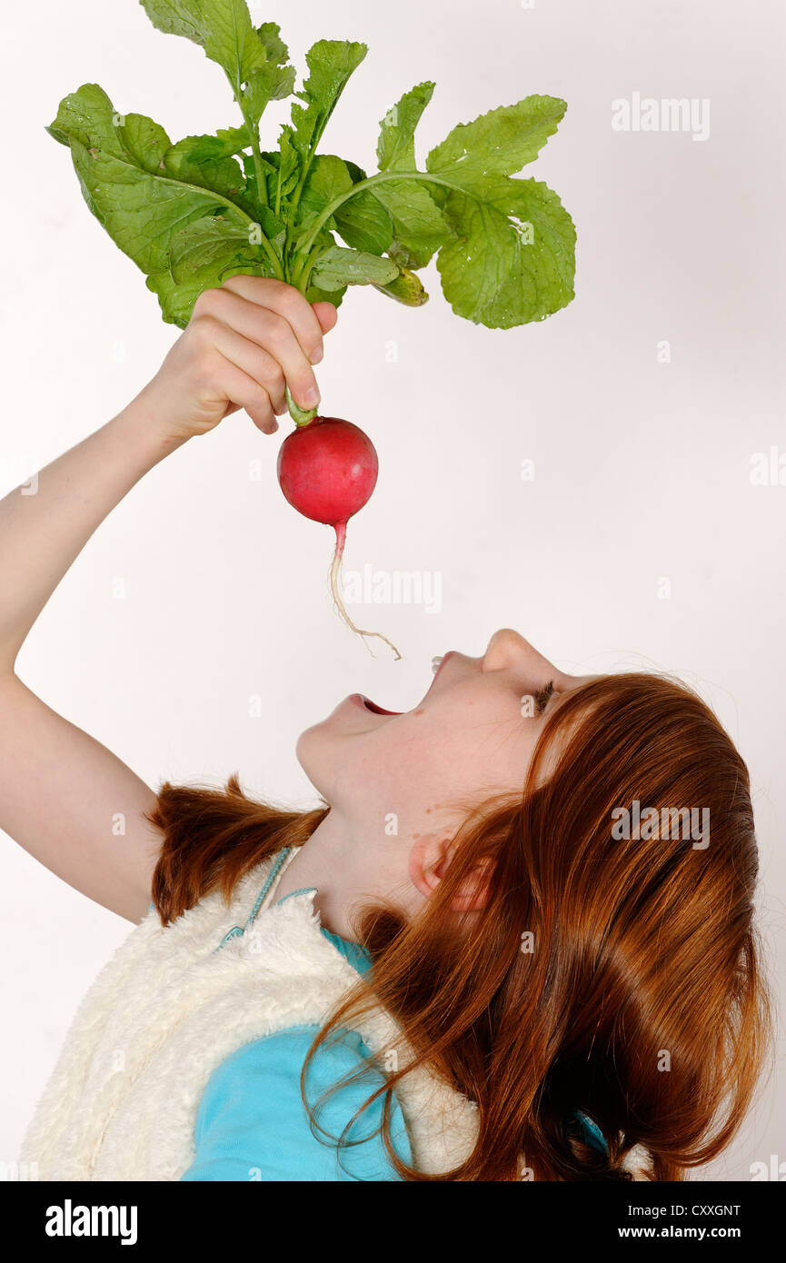 Girl With Radish Stock Photo Alamy