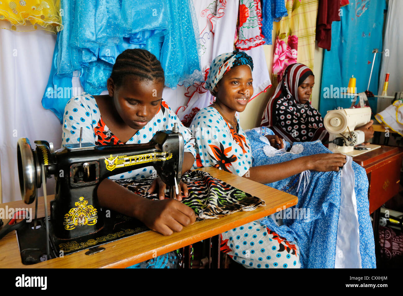 Women with sewing machines in a tailoring shop in Zanzibar / Tanzania Stock Photo