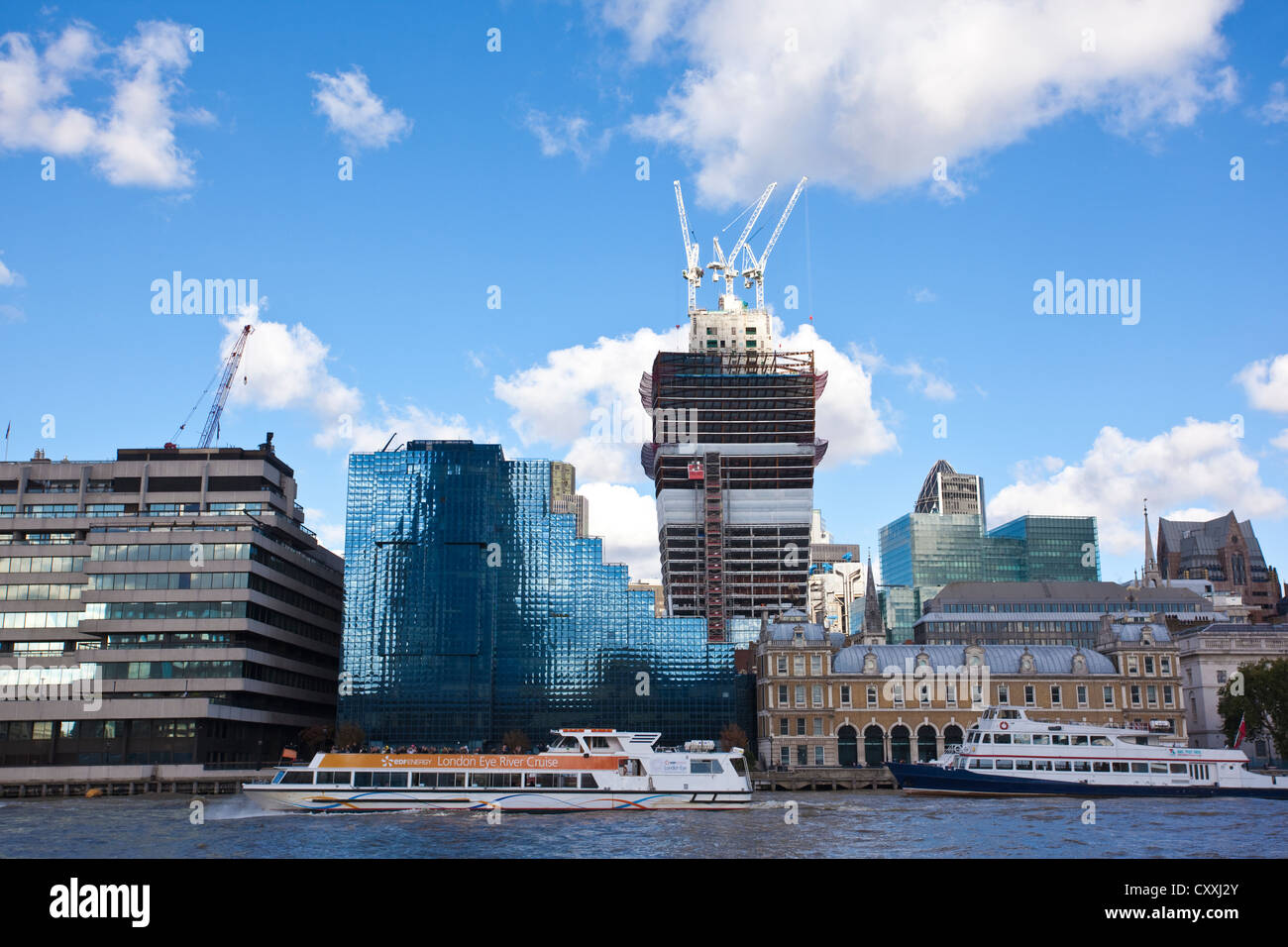 The Northern & Shell Building next to Old Billingsgate Market on north bank of Thames River, overshadowed by the City of London. Stock Photo