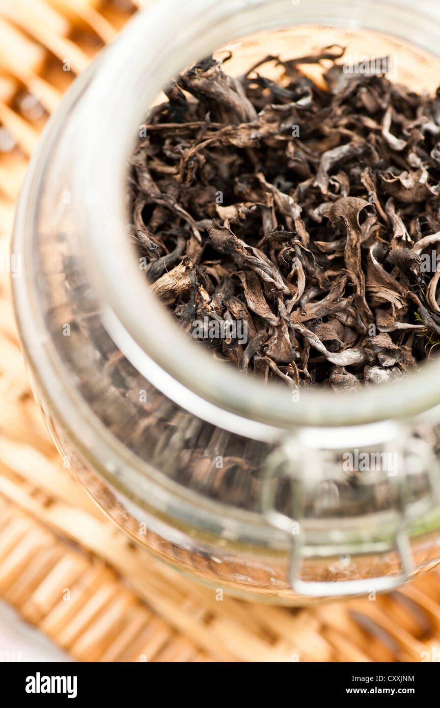 Top view of glass container with dried edible mushrooms (black chanterelle) Stock Photo