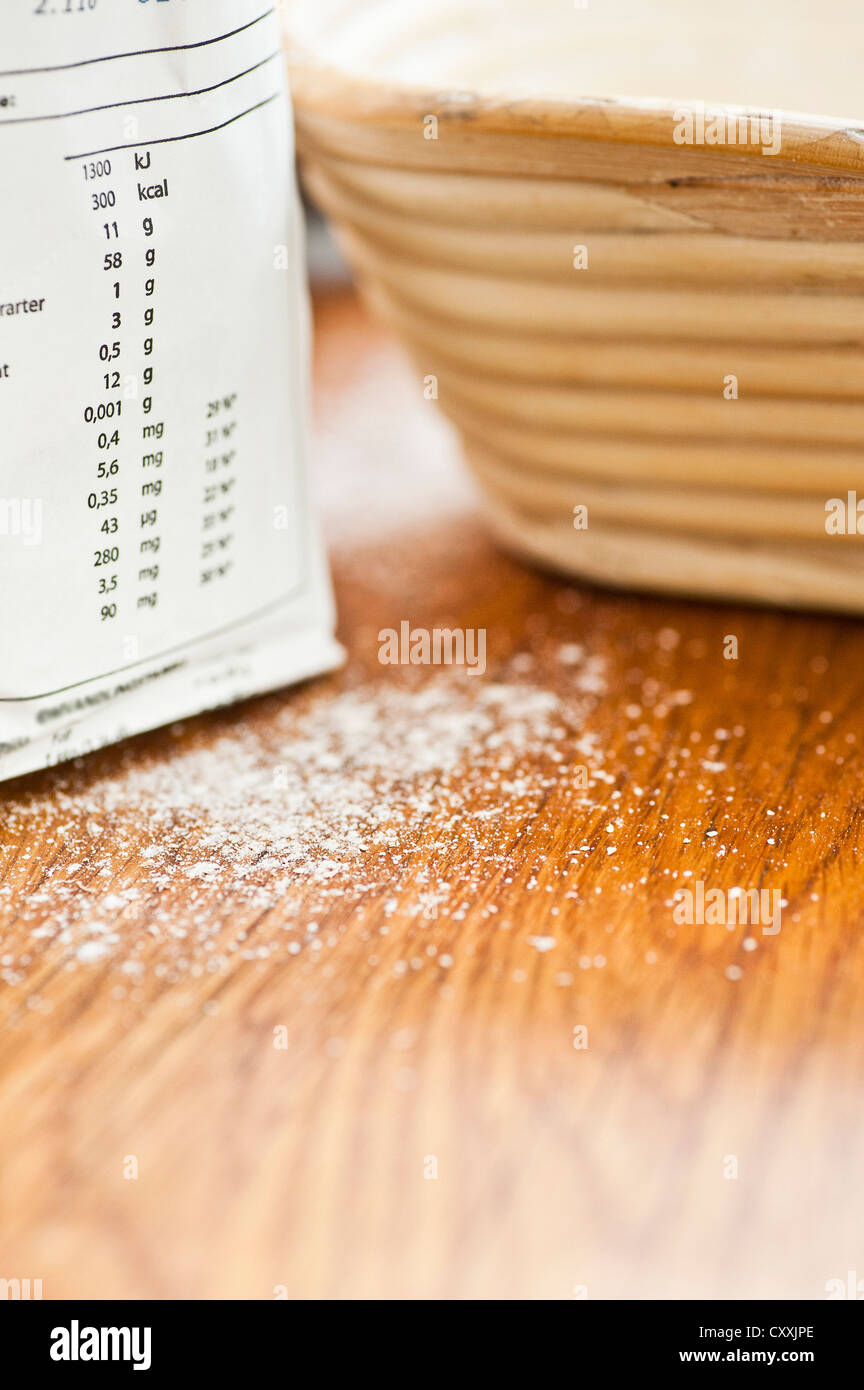 Flour and baking tin on a wooden kitchen counter Stock Photo