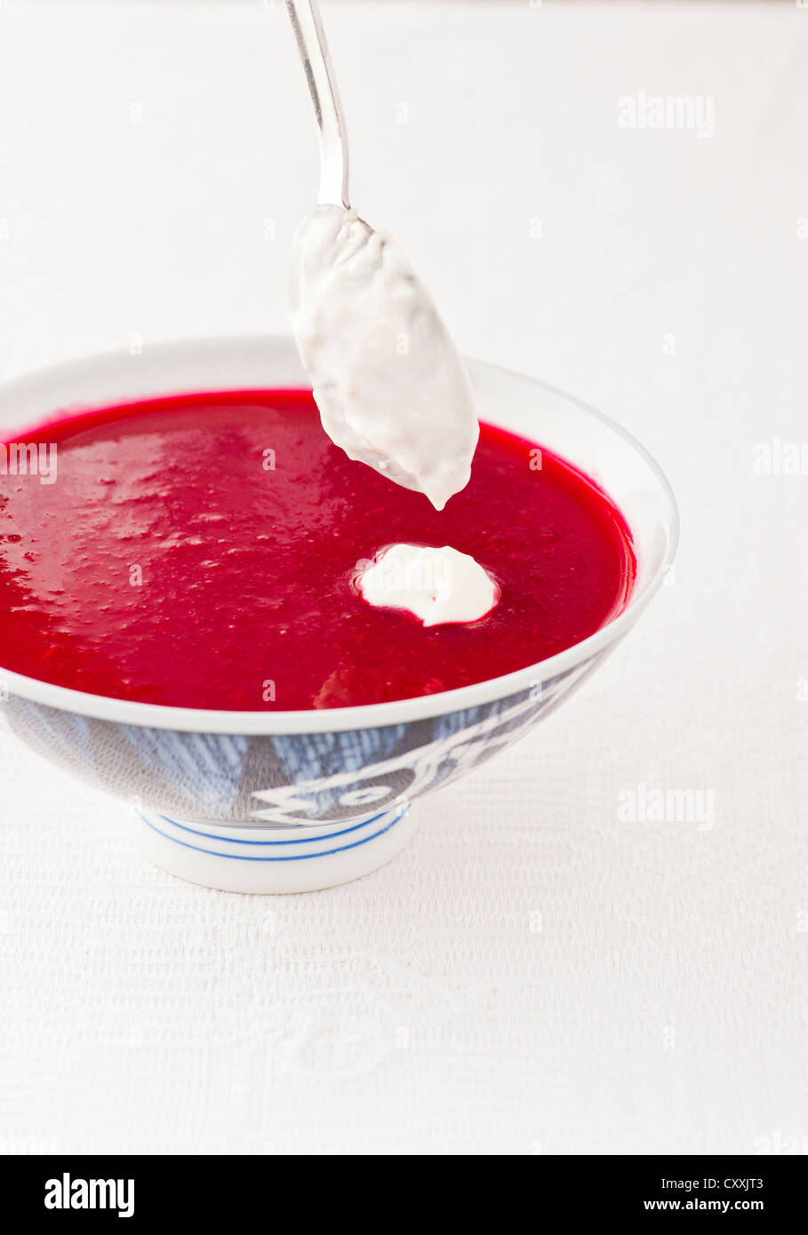 Traditional russian beetroot soup served chilled with sourcream topping Stock Photo