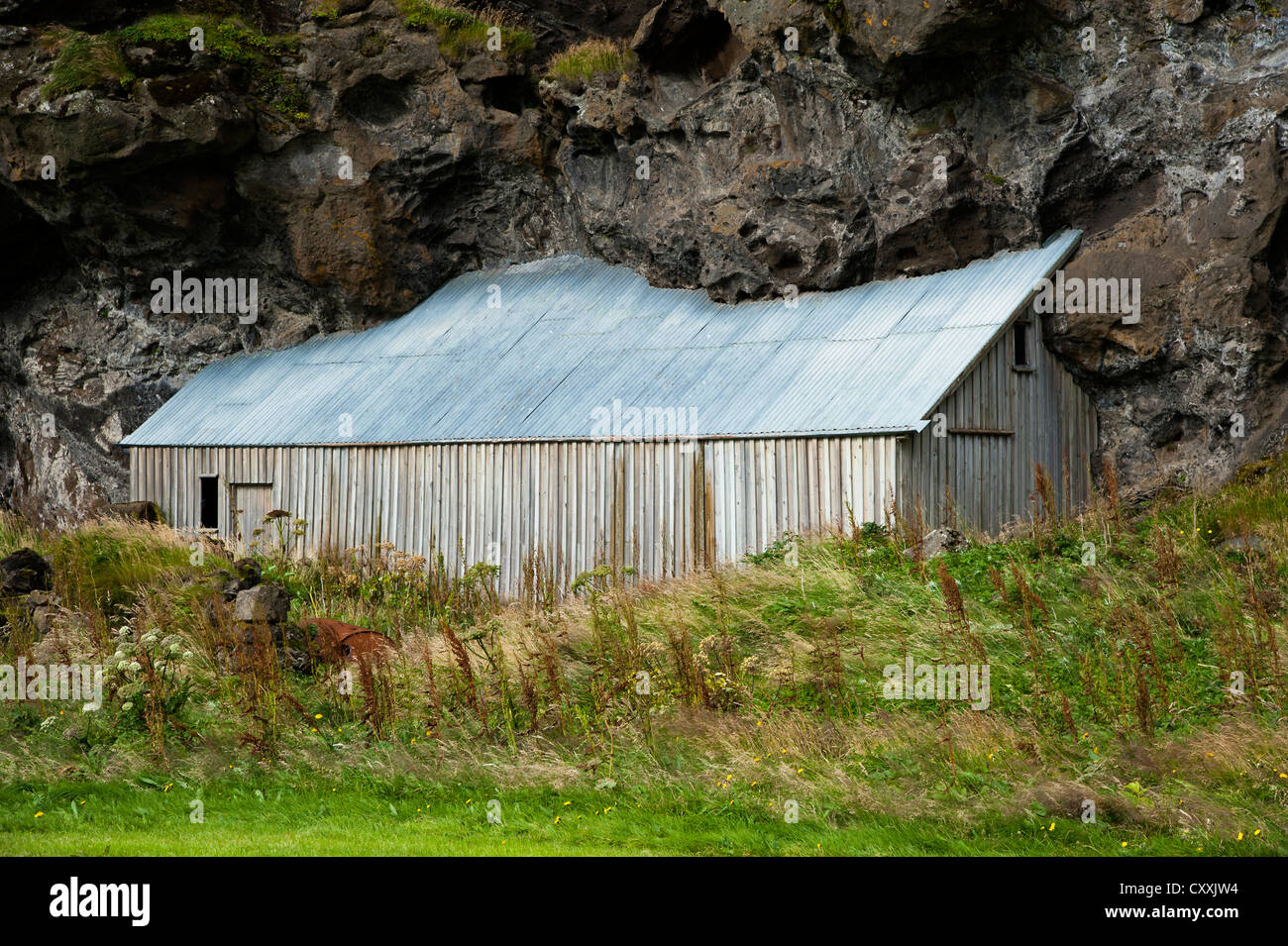 Barn built next to a rock, Austurland, eastern Iceland, Iceland, Europe Stock Photo
