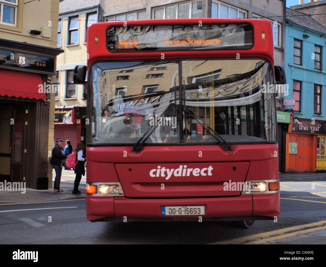 City Direct Irish service bus to Eyre Square, negotiating the narrow roads in Galway City Center in the west of Ireland. Stock Photo