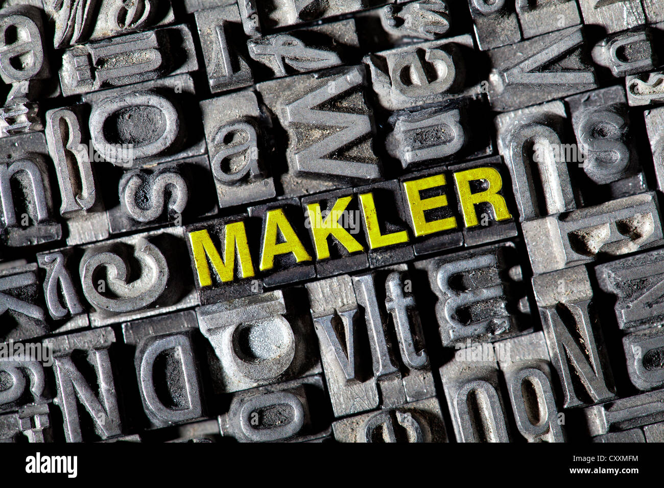 Old lead letters forming the word 'Makler', German for broker Stock Photo