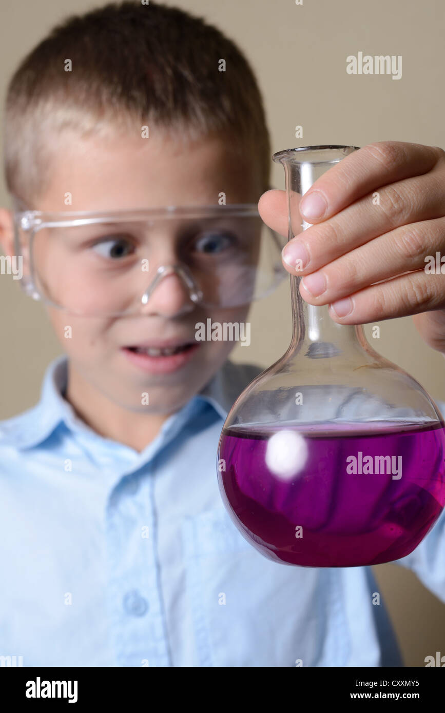 child is doing experiments in chemistry Stock Photo