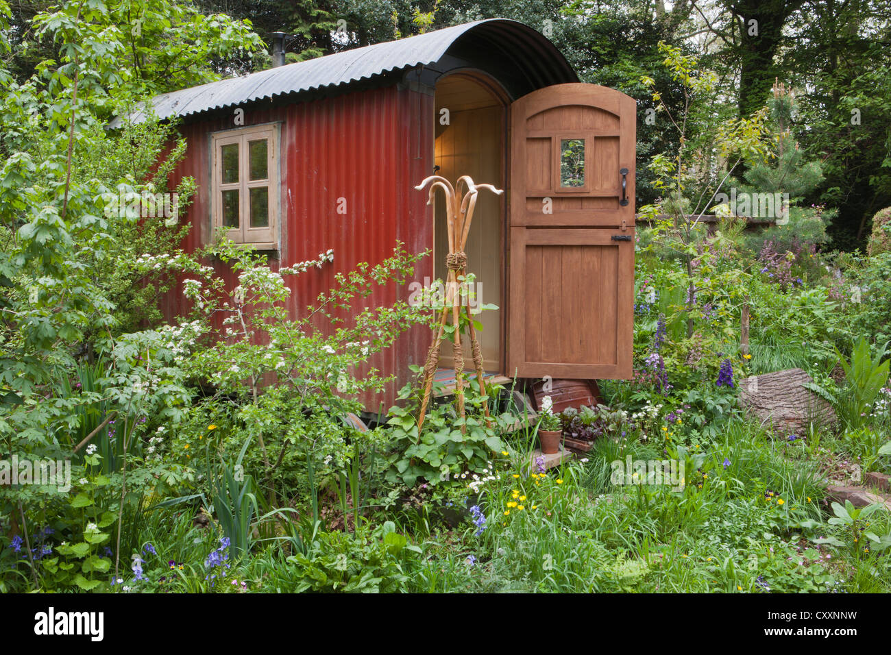 Shepherds hut in a wildflower garden for staycation glamping in the UK Stock Photo