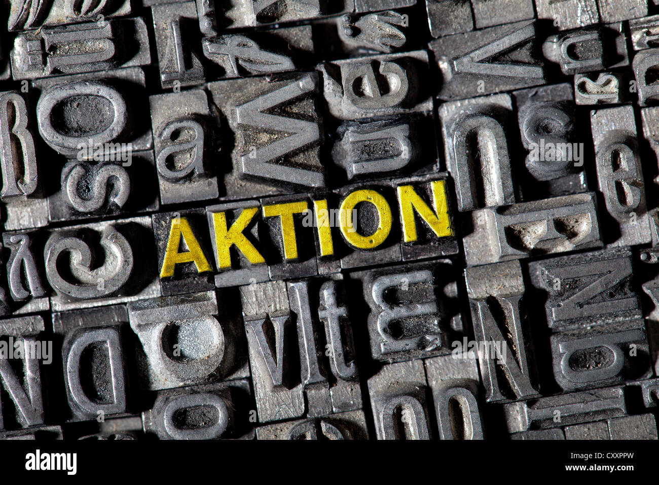 Old lead letters forming the word 'AKTION', German for 'action' Stock Photo