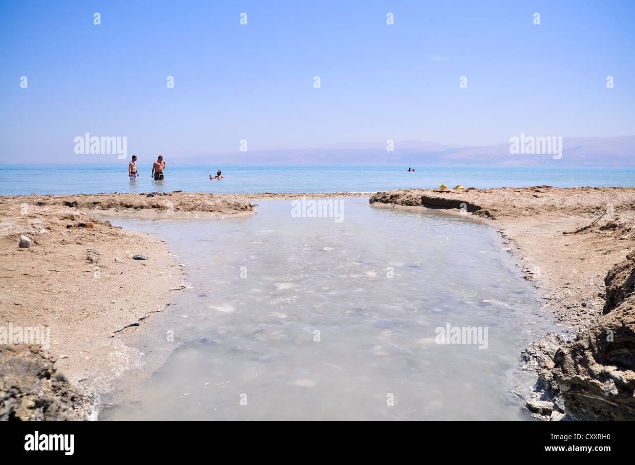 people enjoying the water of the Dead Sea Stock Photo