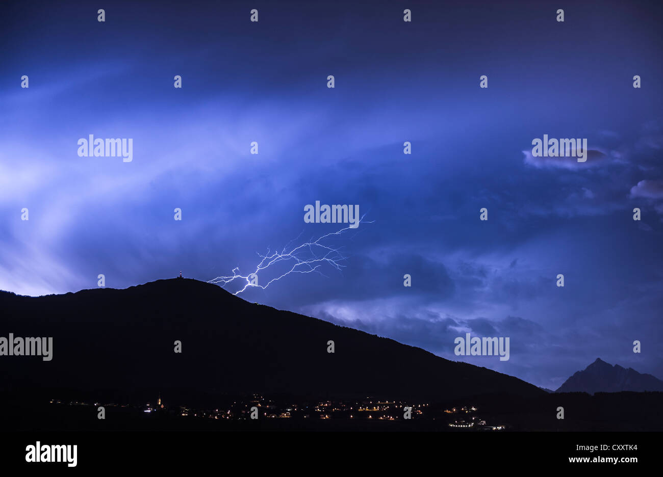 Ominous clouds and lightning bolts from thunderclouds over Mt. Patscherkofel near Innsbruck, night scene, Innsbruck, Tyrol Stock Photo