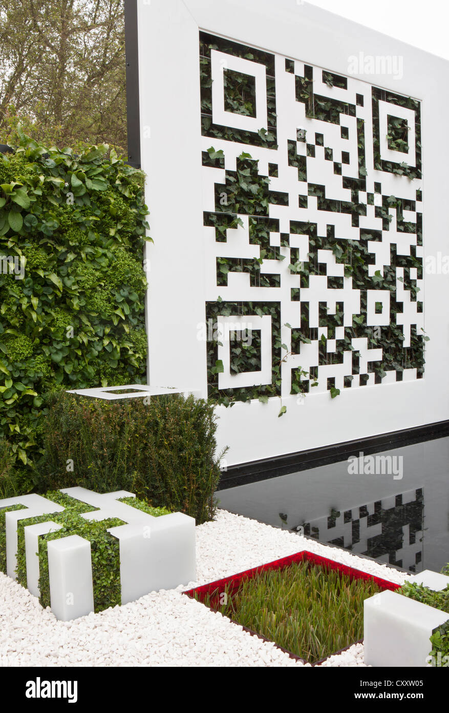 Vertical gardening garden with QR code living wall planted with ferns panel fence wall Chelsea RHS flower show gardens 2012 London UK Stock Photo