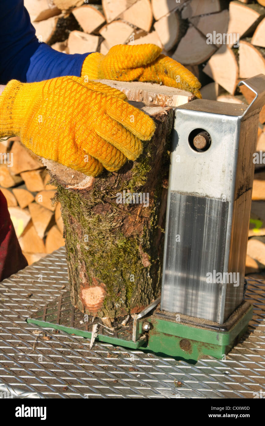 Splitting wood with a wood splitter Stock Photo Alamy