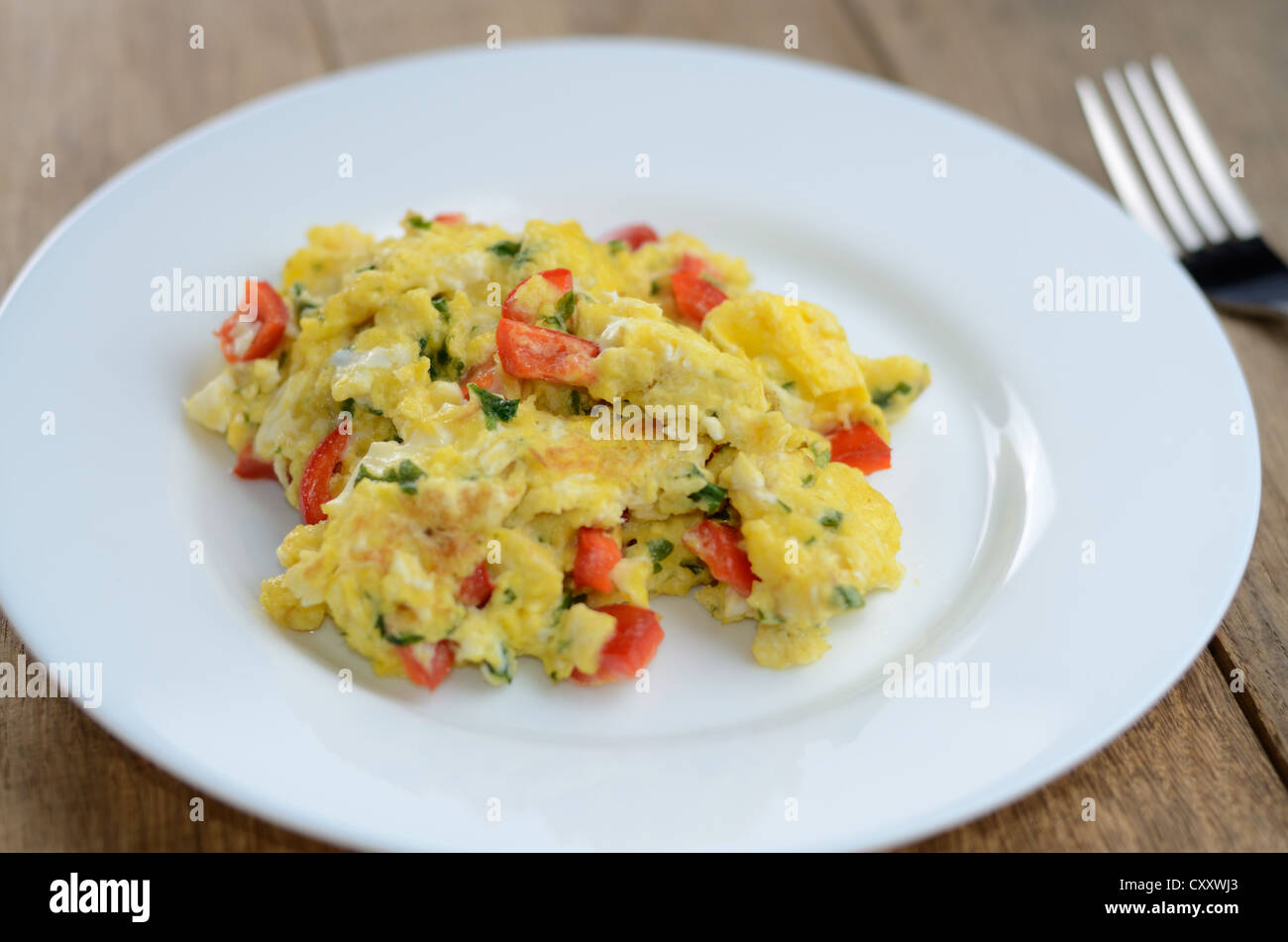 Scrambled eggs on the white plate Stock Photo - Alamy