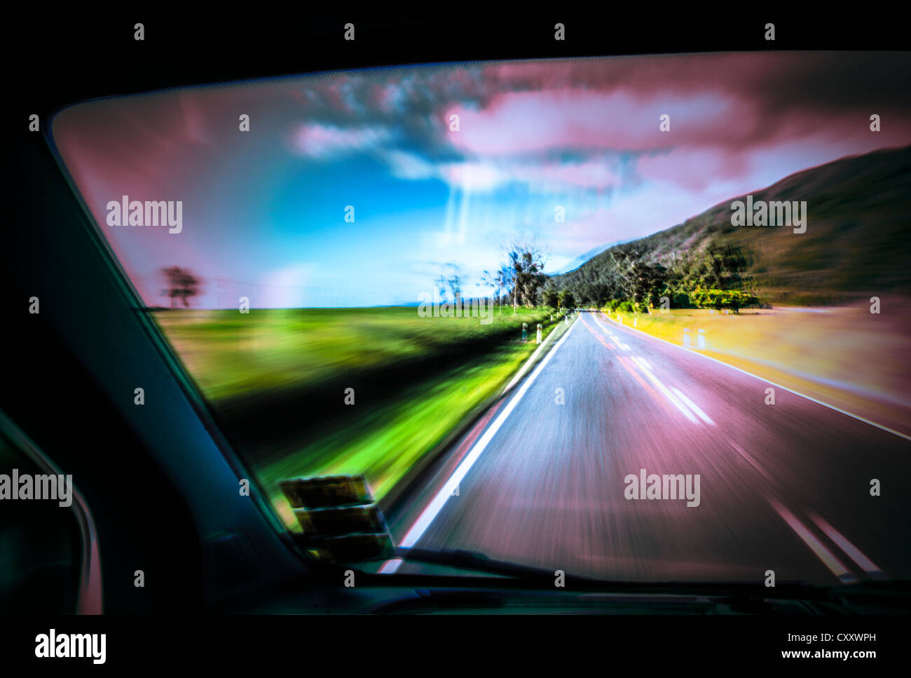 Driving under the influence of drugs, danger to road traffic, driving on the left, view from inside a car on the road Stock Photo