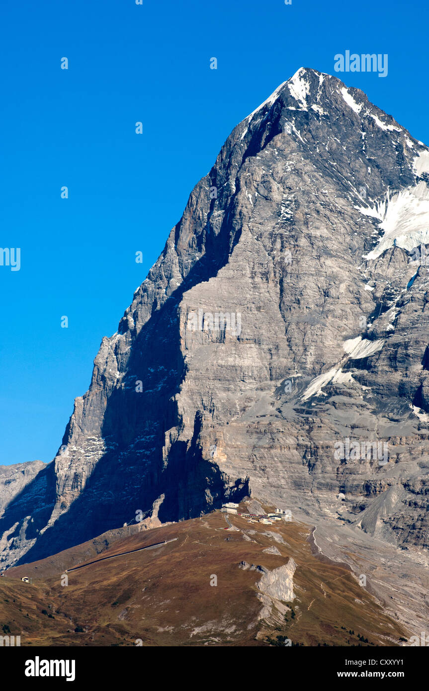 Eiger mountain, Eiger's north face in the shadow, as seen from the west, Eigergletscher station of the Jungfrau-Bahn train at Stock Photo