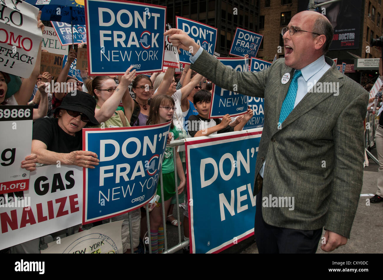 David Braun (right) encourages demonstrators in a Manhattan protest against fracking for natural gas in New York outside NY Governor Cuomo's hotel. Stock Photo