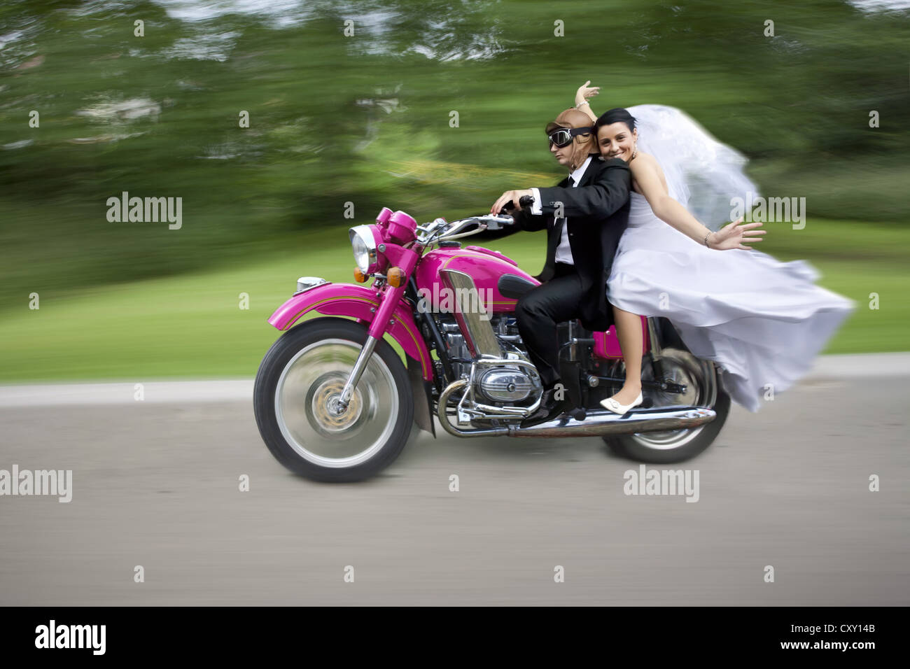 Bridal couple travelling on a motorbike Stock Photo - Alamy