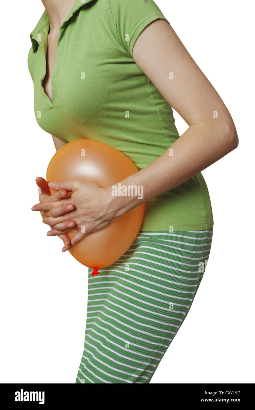 Woman pushing a balloon against her belly, symbolic image for ... Woman pushing a balloon against her belly, symbolic image for ...