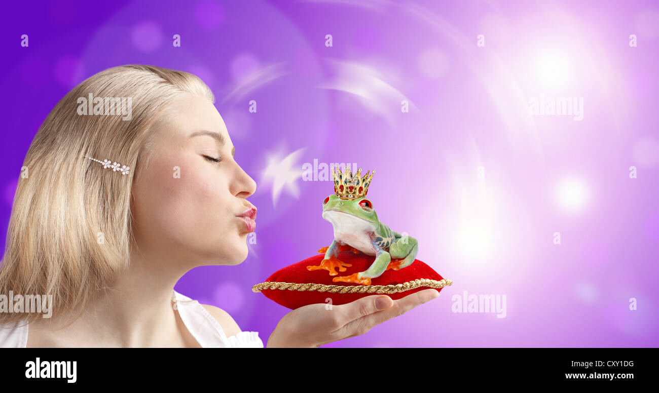 Woman kissing a frog prince Stock Photo