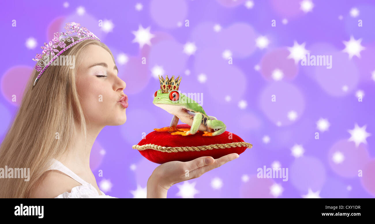 Woman kissing a frog prince Stock Photo