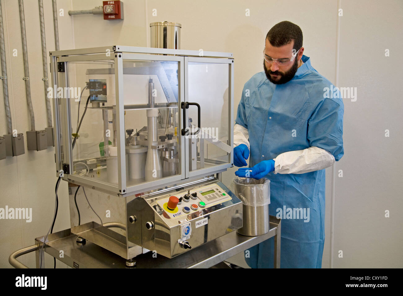 A chemist dressed in safety gear works in research at a at a pharmacutical research laboratory Stock Photo