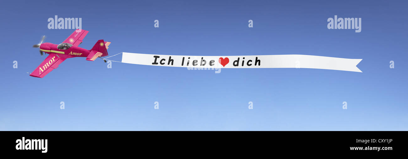 Plane in the sky pulling a banner with the message Ich liebe dich, German for I love you, illustration Stock Photo