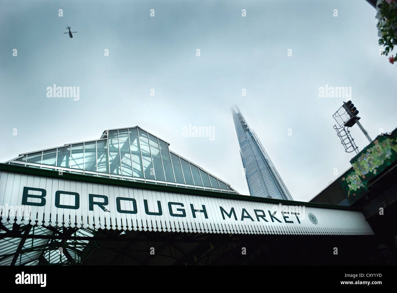 Borough Market and the Shard skyscraper, London with helicopter flying over head and a moody, grey sky. Stock Photo