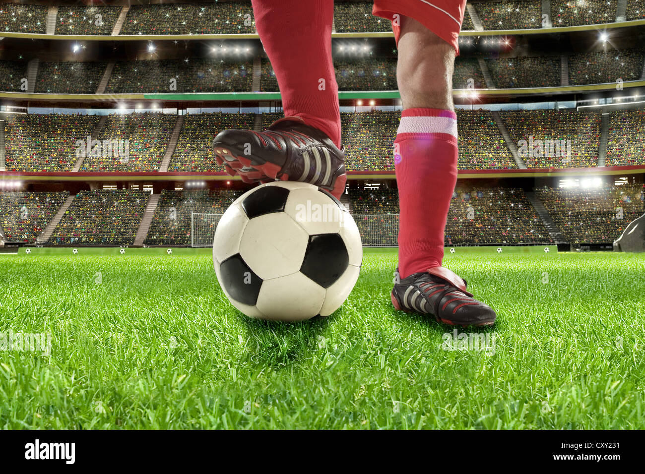 Soccer player, legs, soccer ball, soccer stadium Stock Photo