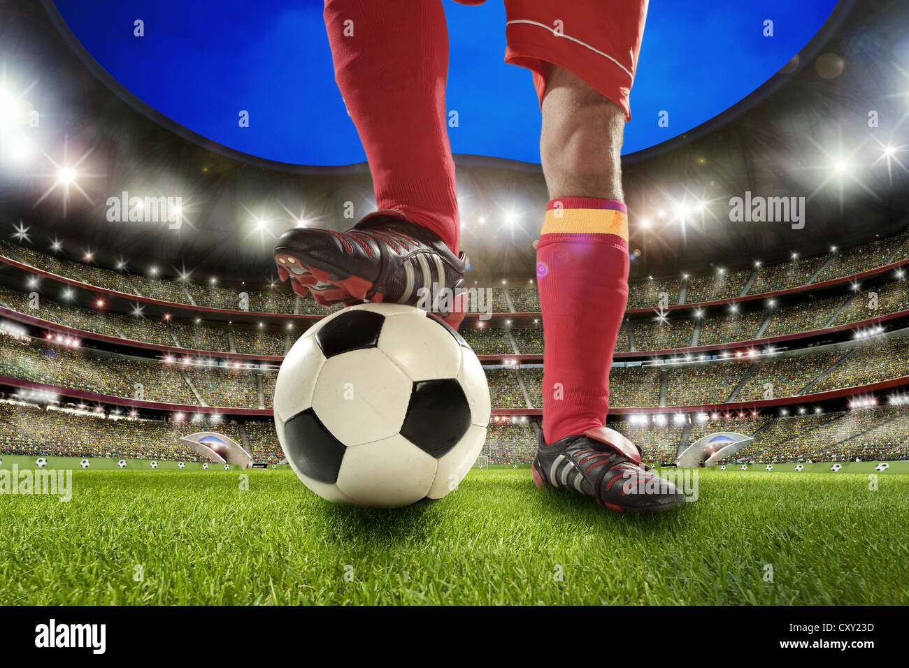 Soccer player, legs, soccer ball, soccer stadium Stock Photo