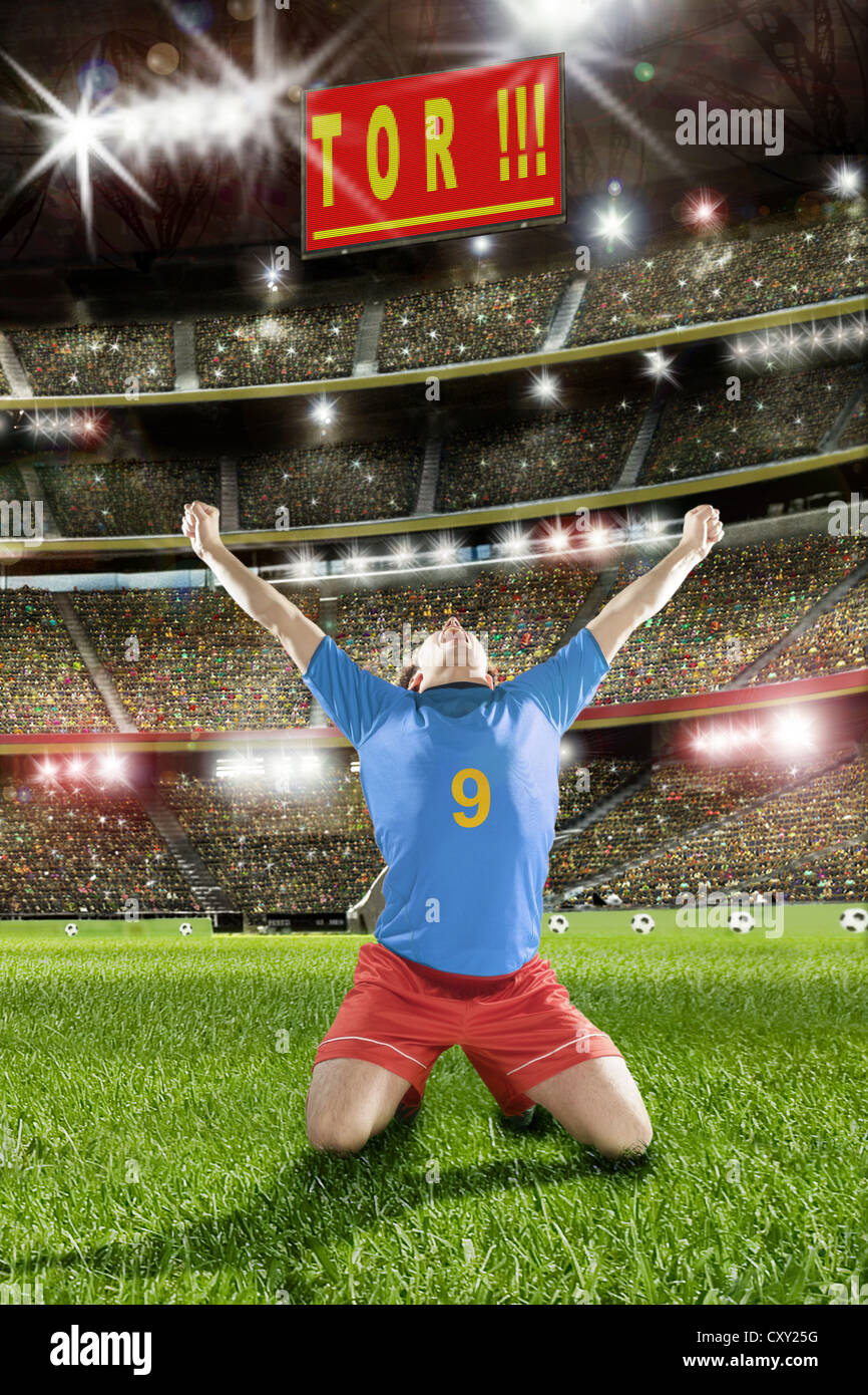 Cheering soccer player, scoreboard, lettering 'Tor', German for 'goal', soccer stadium Stock Photo