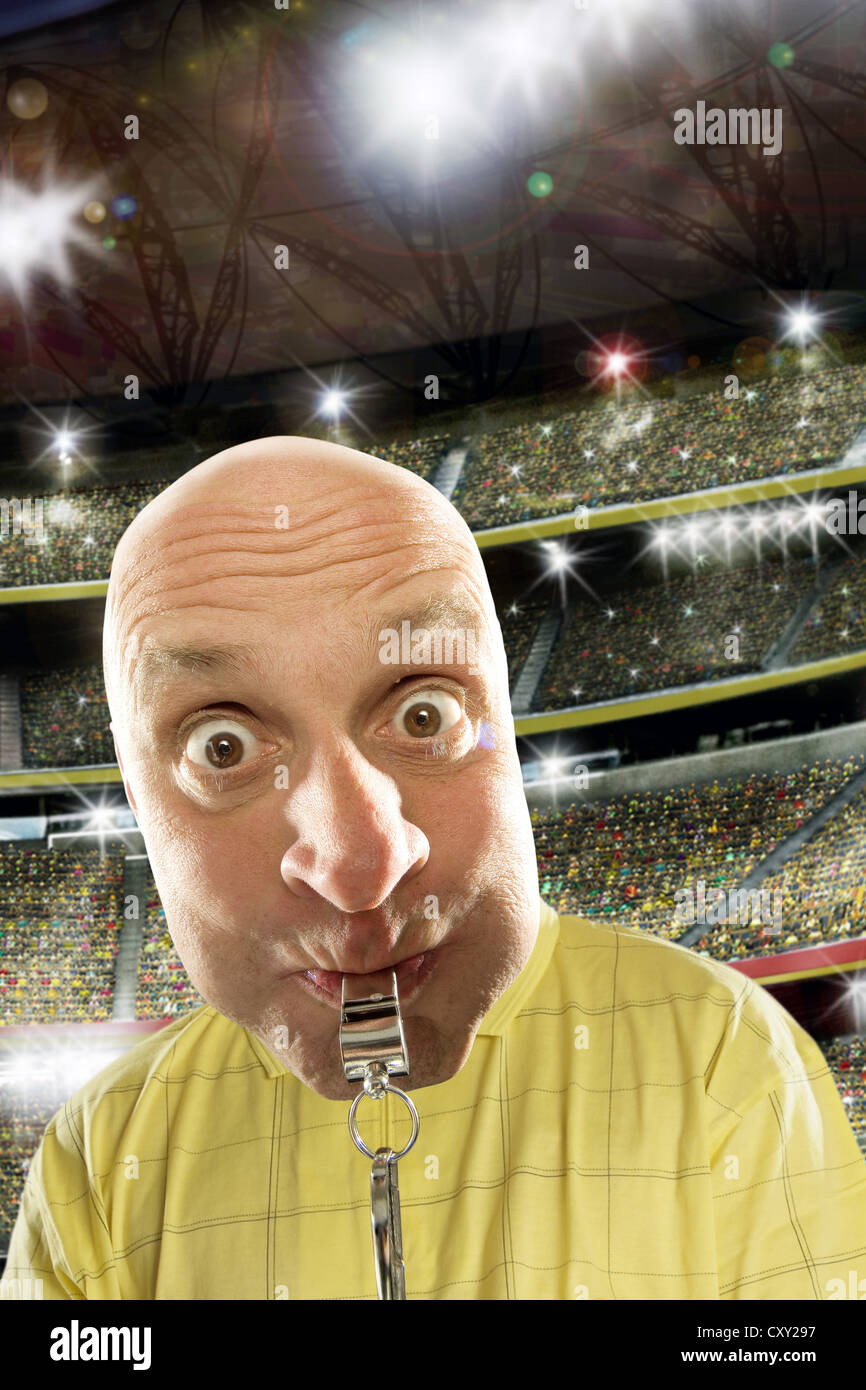 Referee with a whistle, soccer stadium Stock Photo