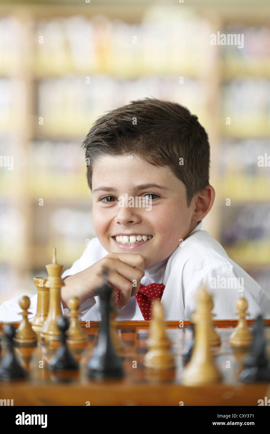 Smiling boy playing chess Stock Photo