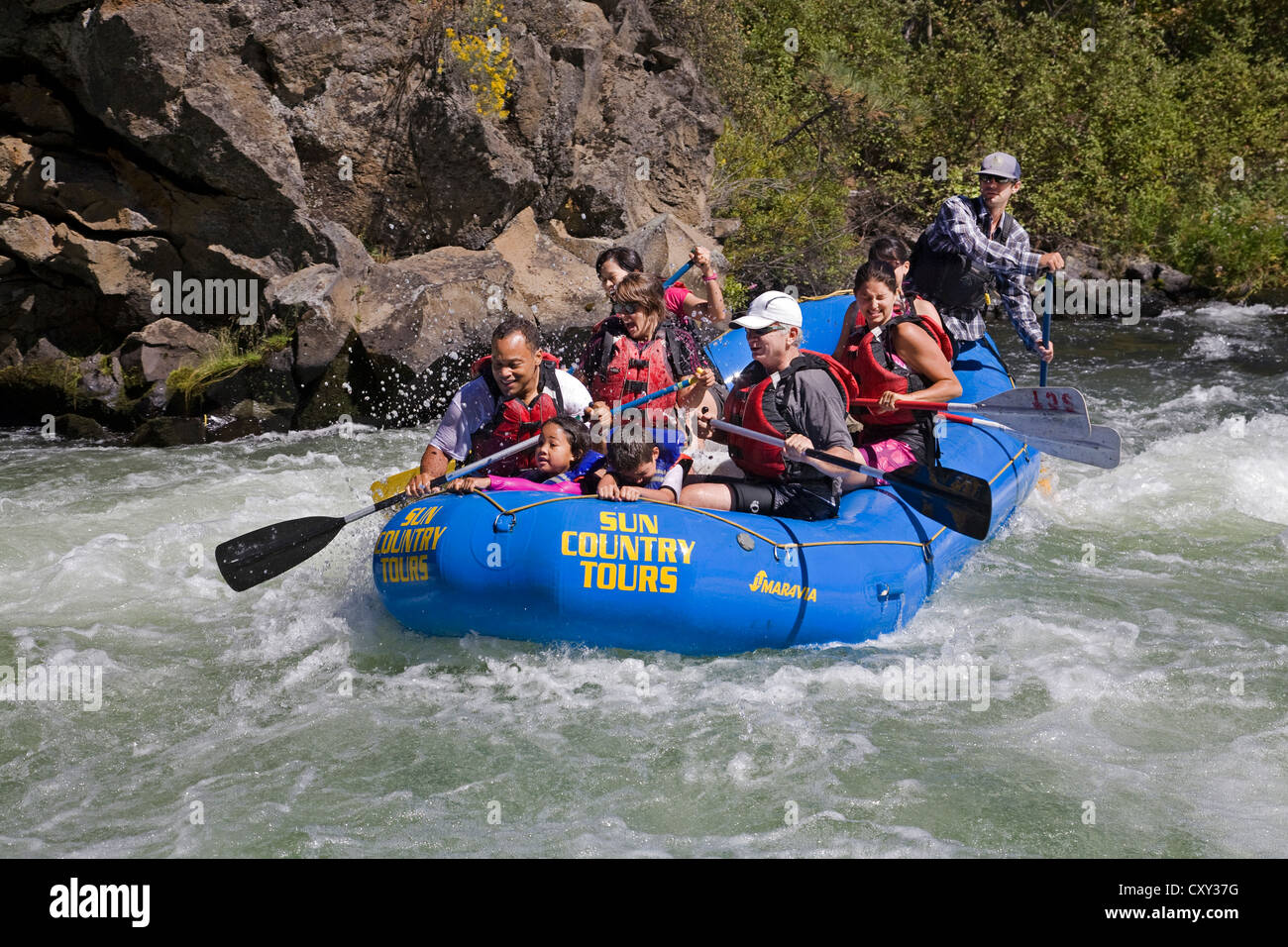 Whitewater rafters shoot the rapids of the Deschutes River in a paddle boat, near Bend, Oregon, in the summer, Stock Photo