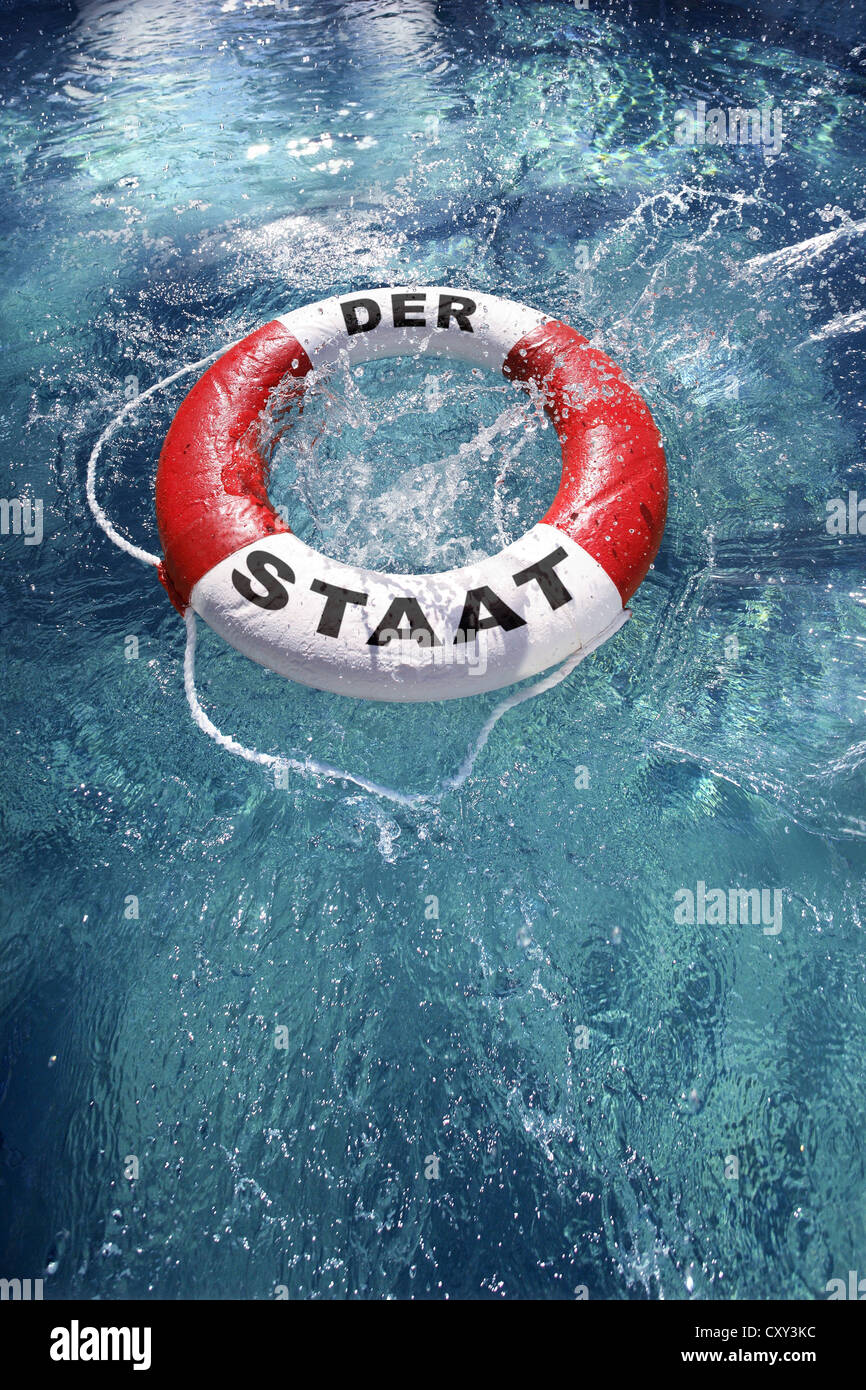 Life ring labelled Der Staat, German for the nation, being thrown into the water, symbolic image Stock Photo