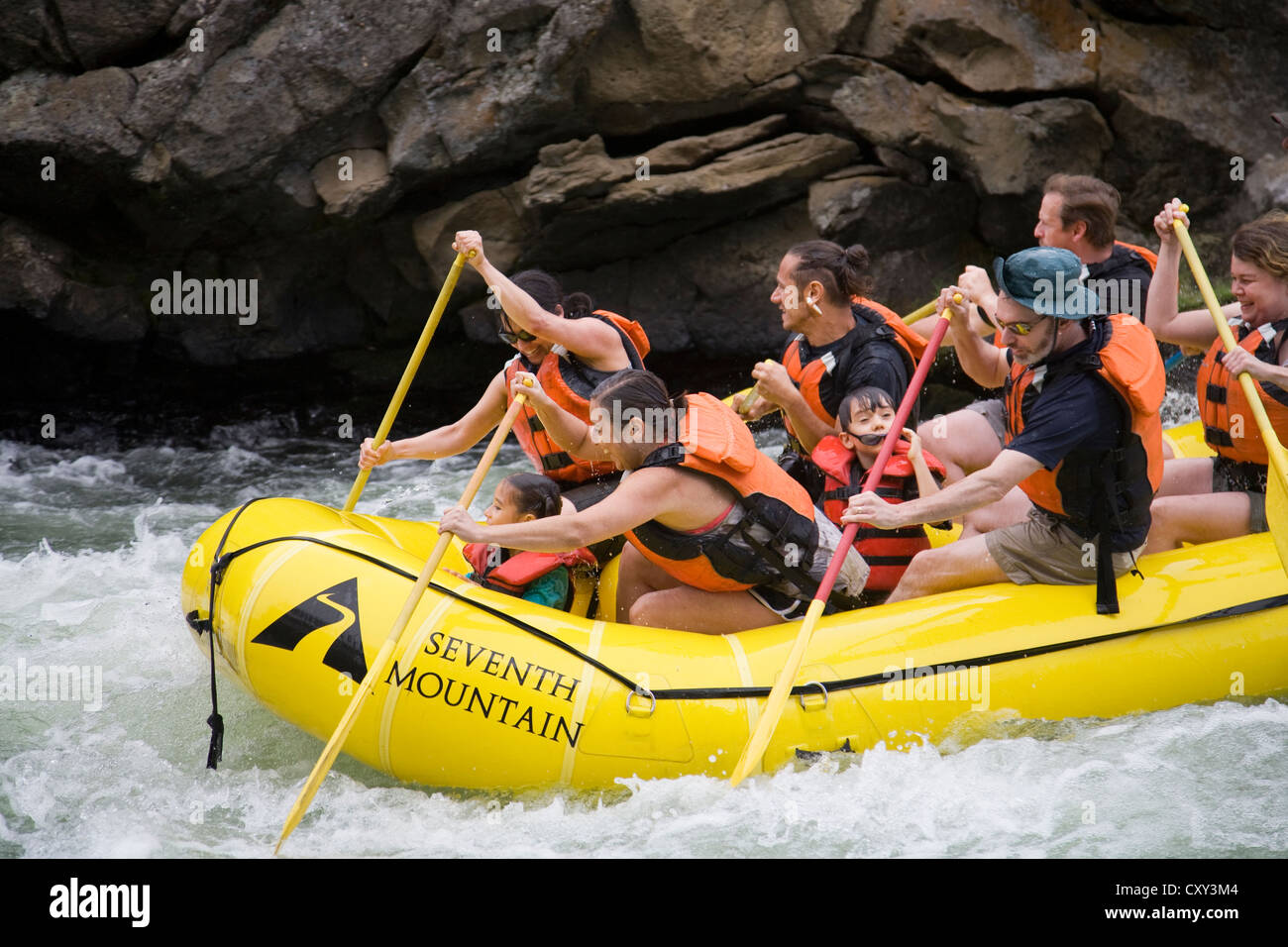 Whitewater rafters shoot the rapids of the Deschutes River in a paddle boat, near Bend, Oregon, in the summer, Stock Photo