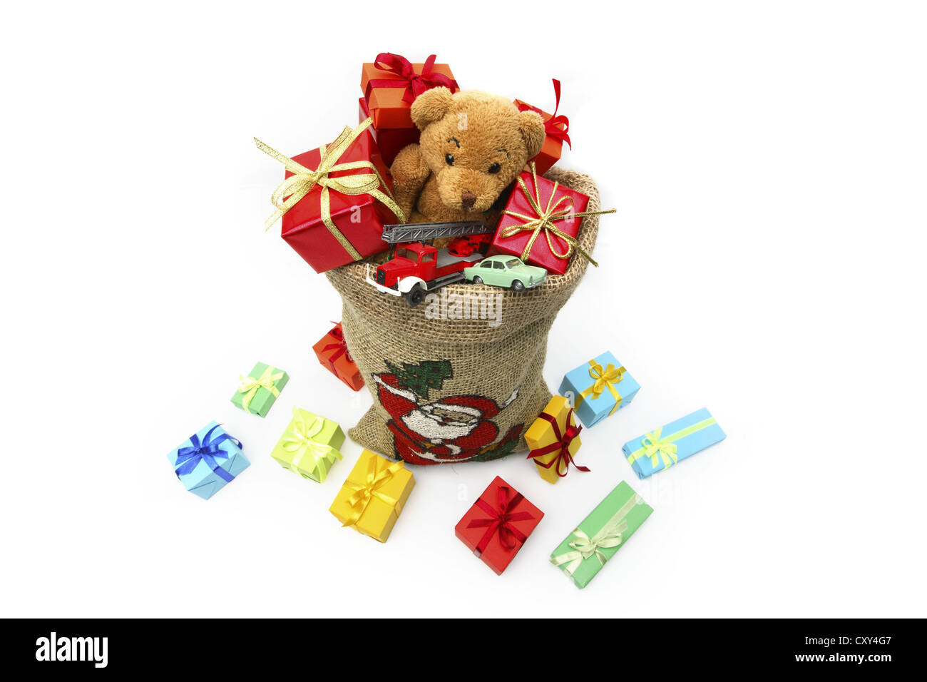 Christms sack filled with Christmas gifts, a teddy bear and toy cars Stock Photo