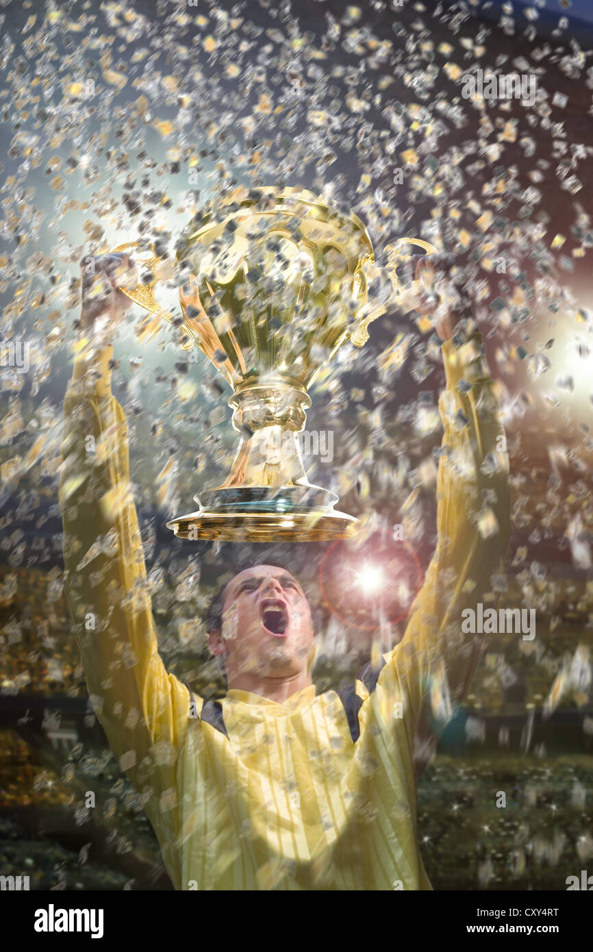 Football player, cup, cheering, confetti, football stadium Stock Photo