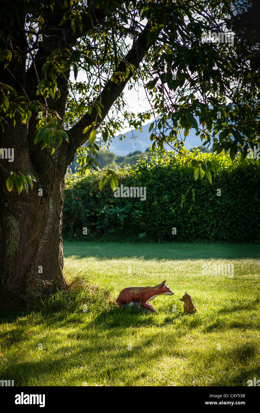 Ornamental fox and cub in a country garden in UK Stock Photo