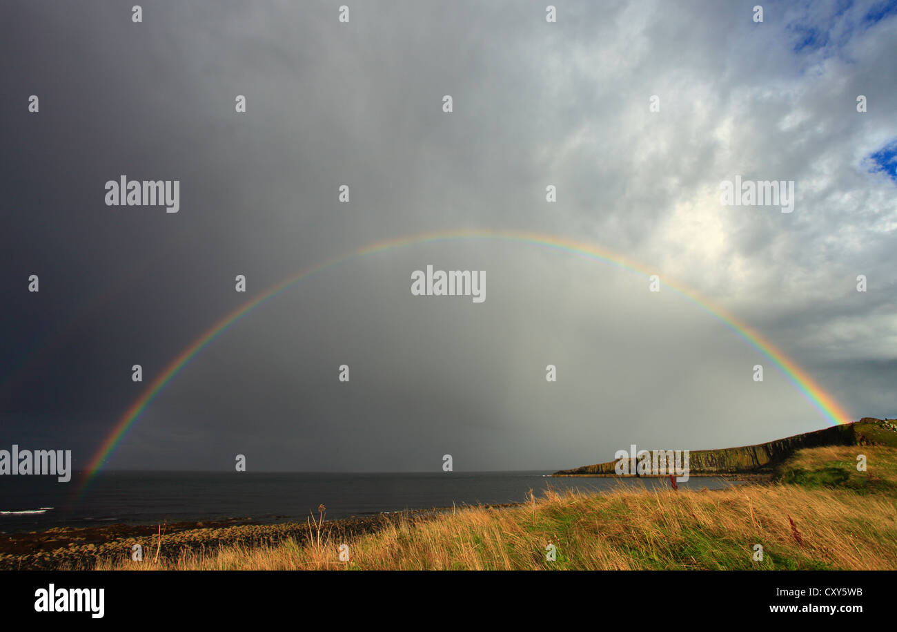 Embleton Bay, Northumberland, at the end of the day with a rainbow over the sea. Stock Photo