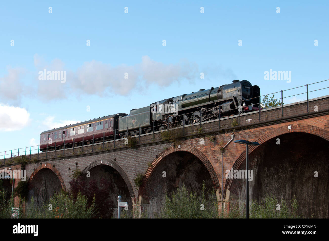 Steam locomotive No.70013 "Oliver Cromwell" crossing the viaduct at  Worcester, UK Stock Photo