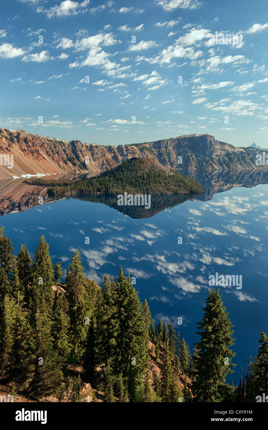 Morning clouds float over Wizard Island reflecting into Oregon's Crater Lake National Park. Stock Photo