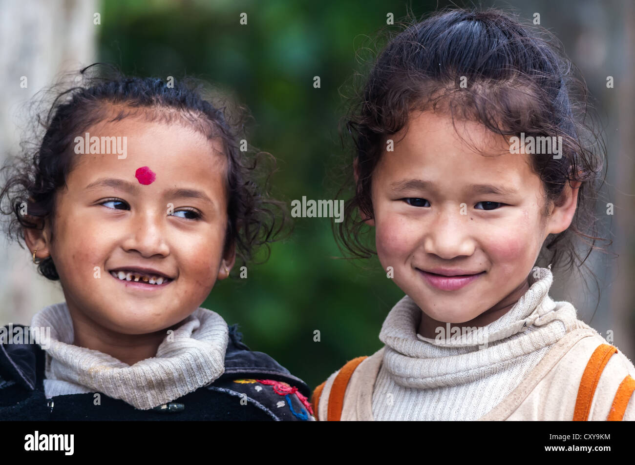 Two sisters, children, smiling, one facing camera, Nepali girls, Close-up, copy space Stock Photo