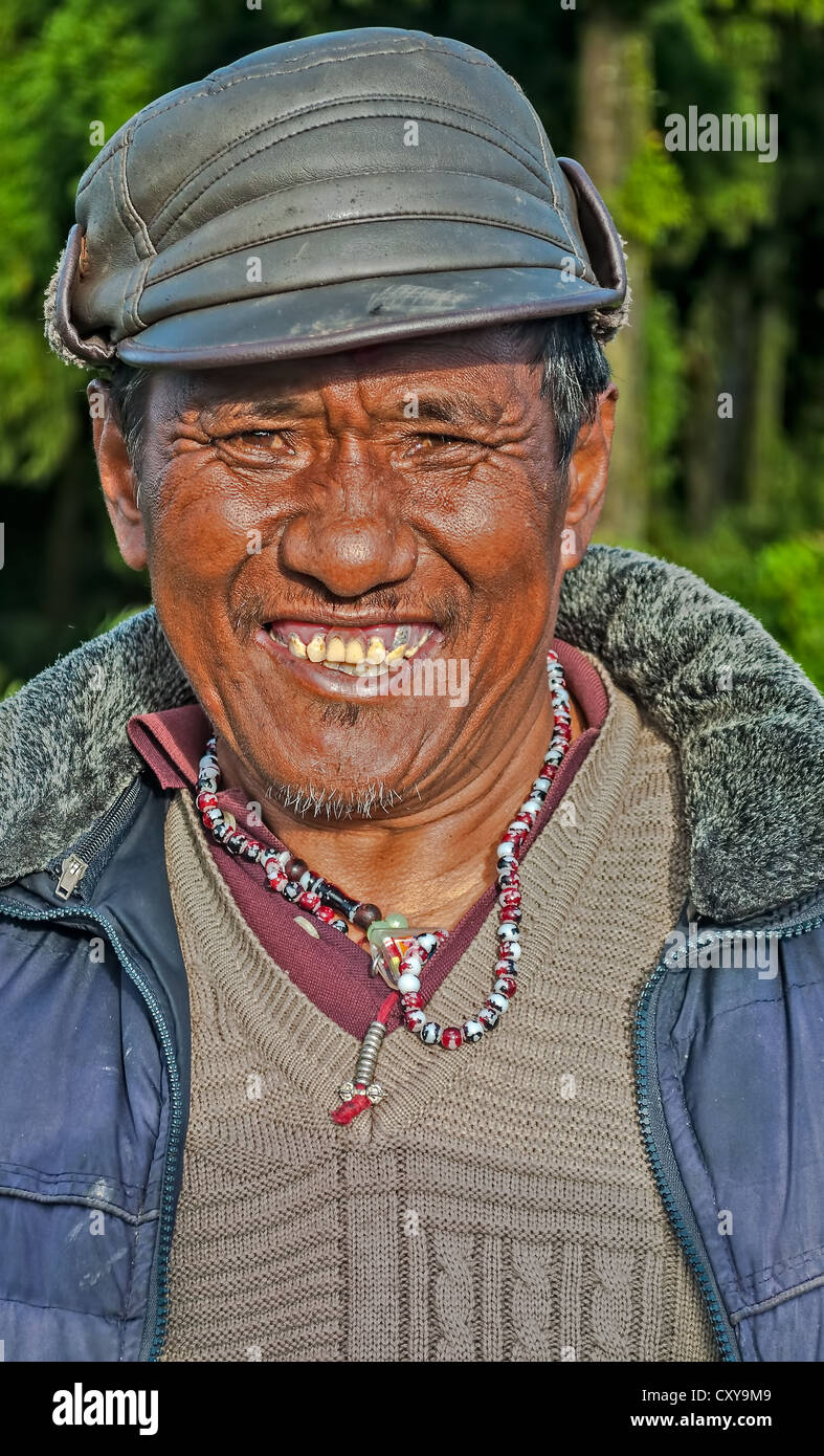 Old Nepali Buddhist Man, portrait, smiling, with cap, facing camera, copy space, outdoor, sunlight, Stock Photo