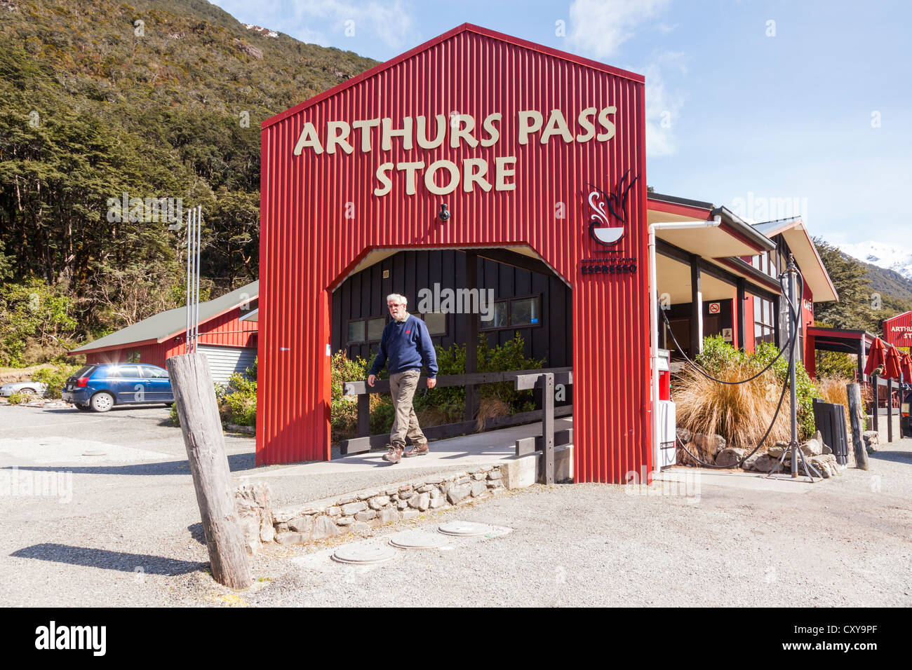 Arthurs Pass Store, Arthurs Pass, Canterbury, New Zealand, a man just walking out, on a bright sunny spring day. Stock Photo