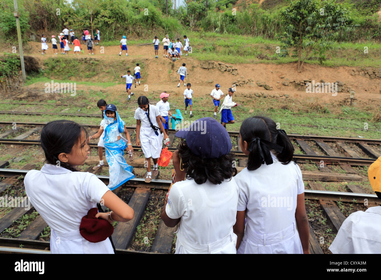 Schoolchildren at Demodara train station near Ella in the Sri Lanka highlands. Stock Photo