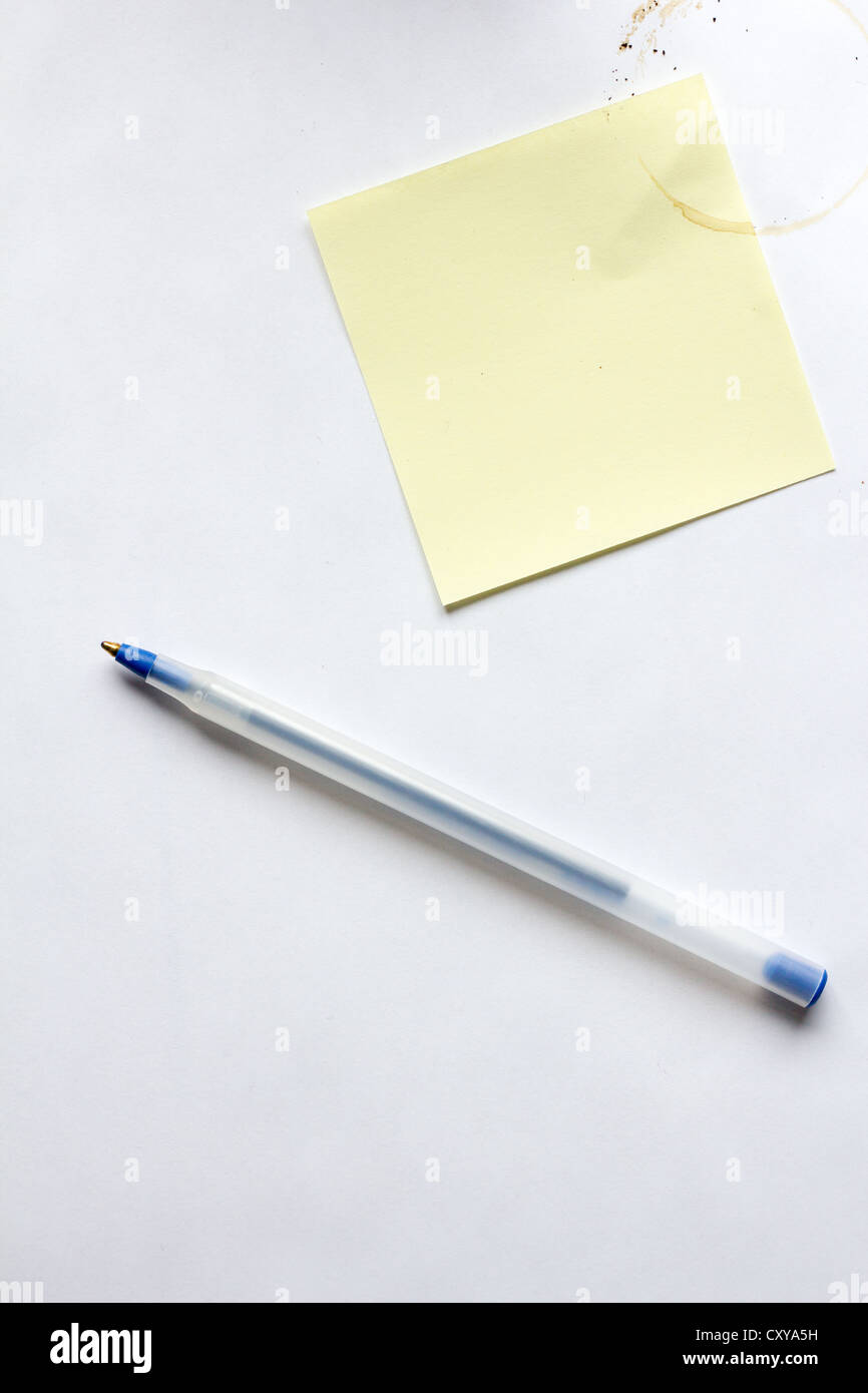 pen, paper, sticky note, coffee stain - Stock Image